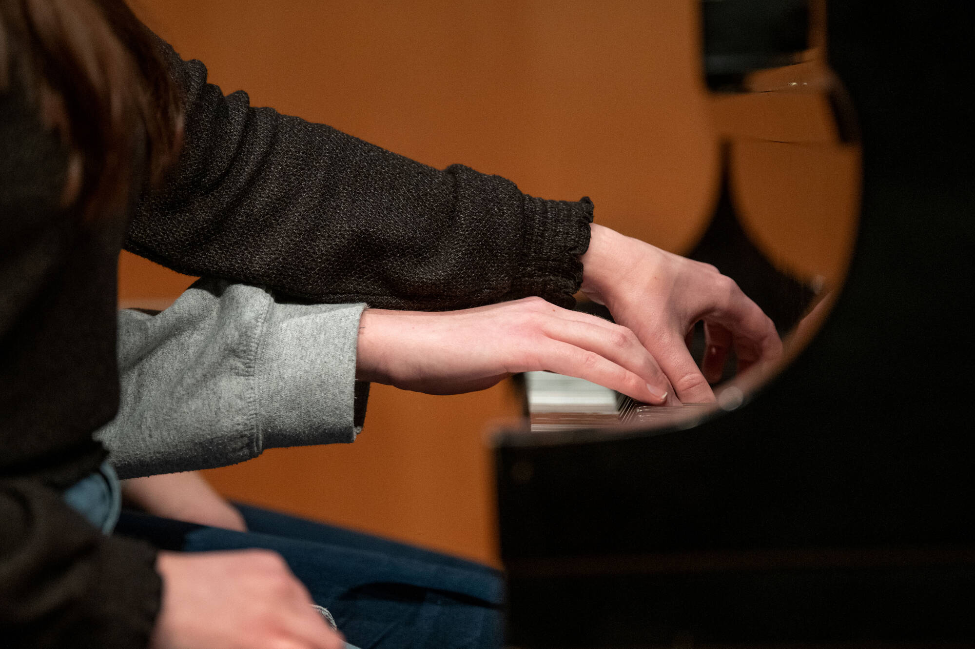 two hands playing piano
